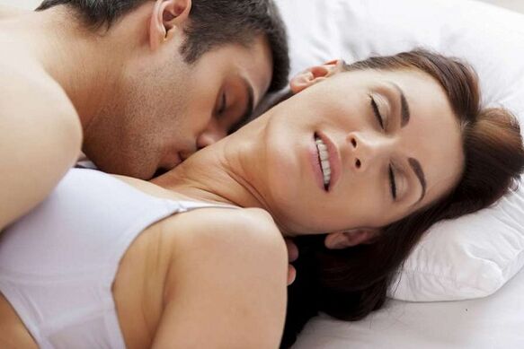 Excited man and female in bed